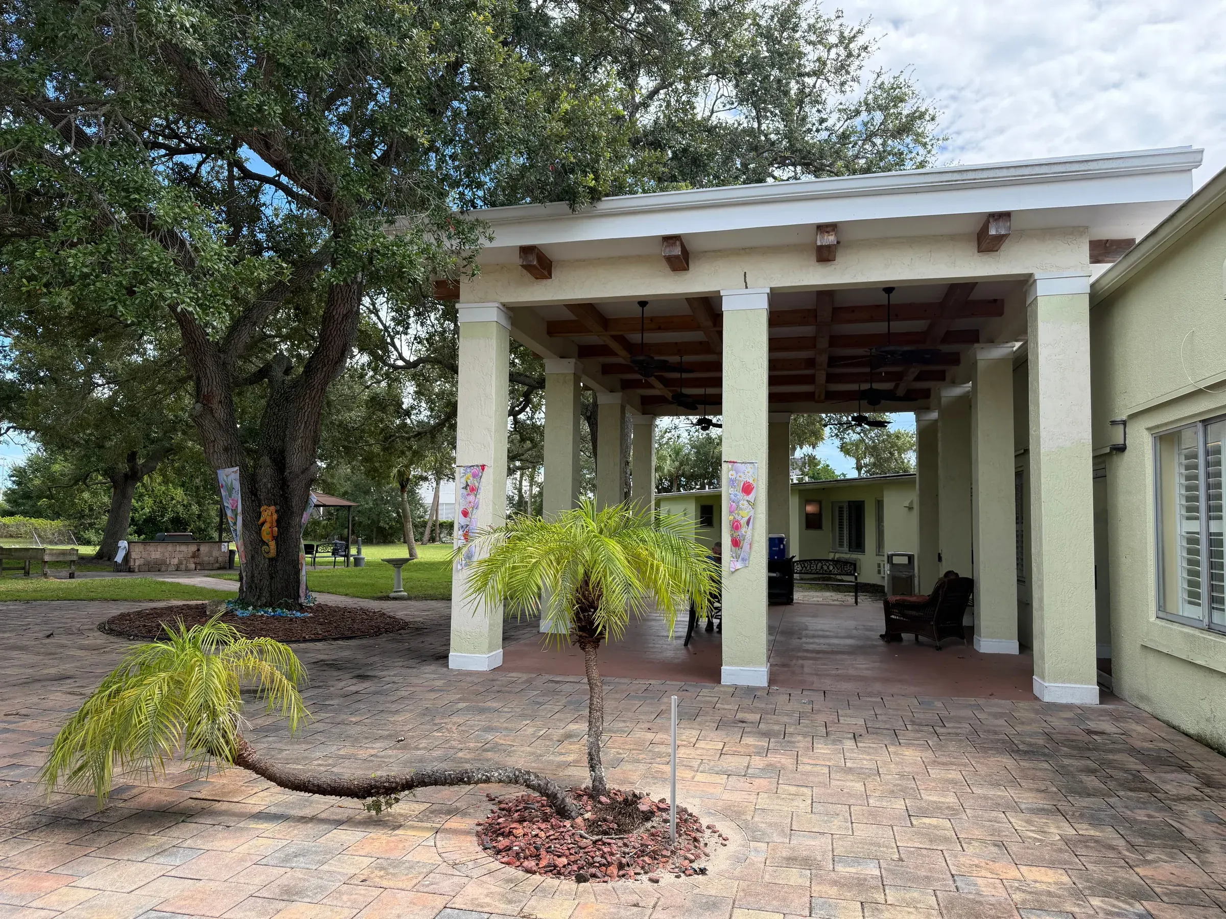 The courtyard pavilion at Vivo Healthcare Fort Pierce, under live oaks