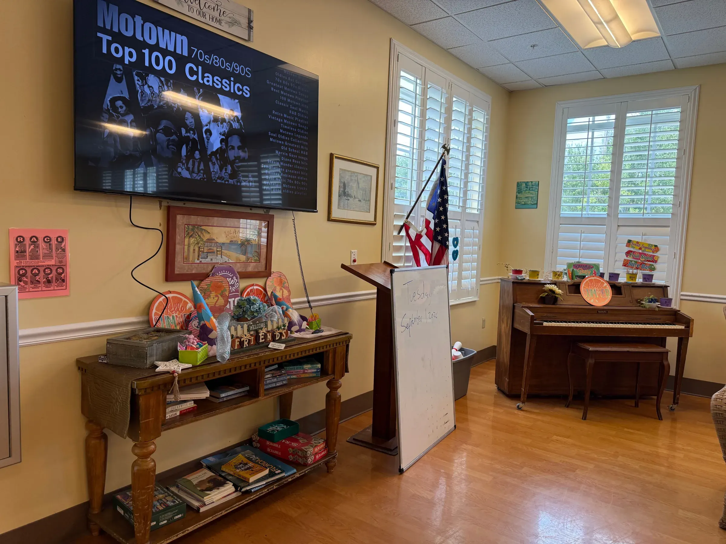 The music room at Vivo Healthcare Fort Pierce, with a piano and the day's activity board